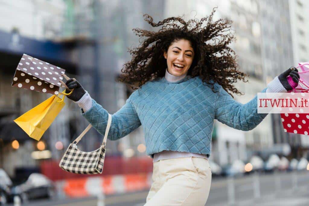 Happy woman jumping with shopping bags