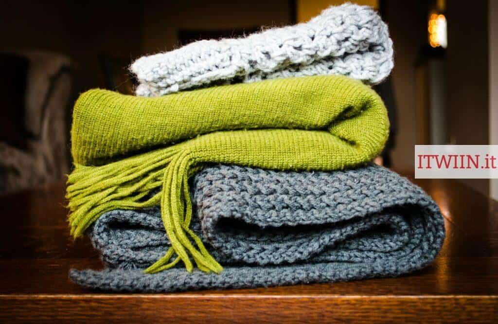 three gray, green, and white scarf on top of table