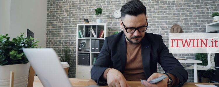 a man sitting at a table in front of a laptop